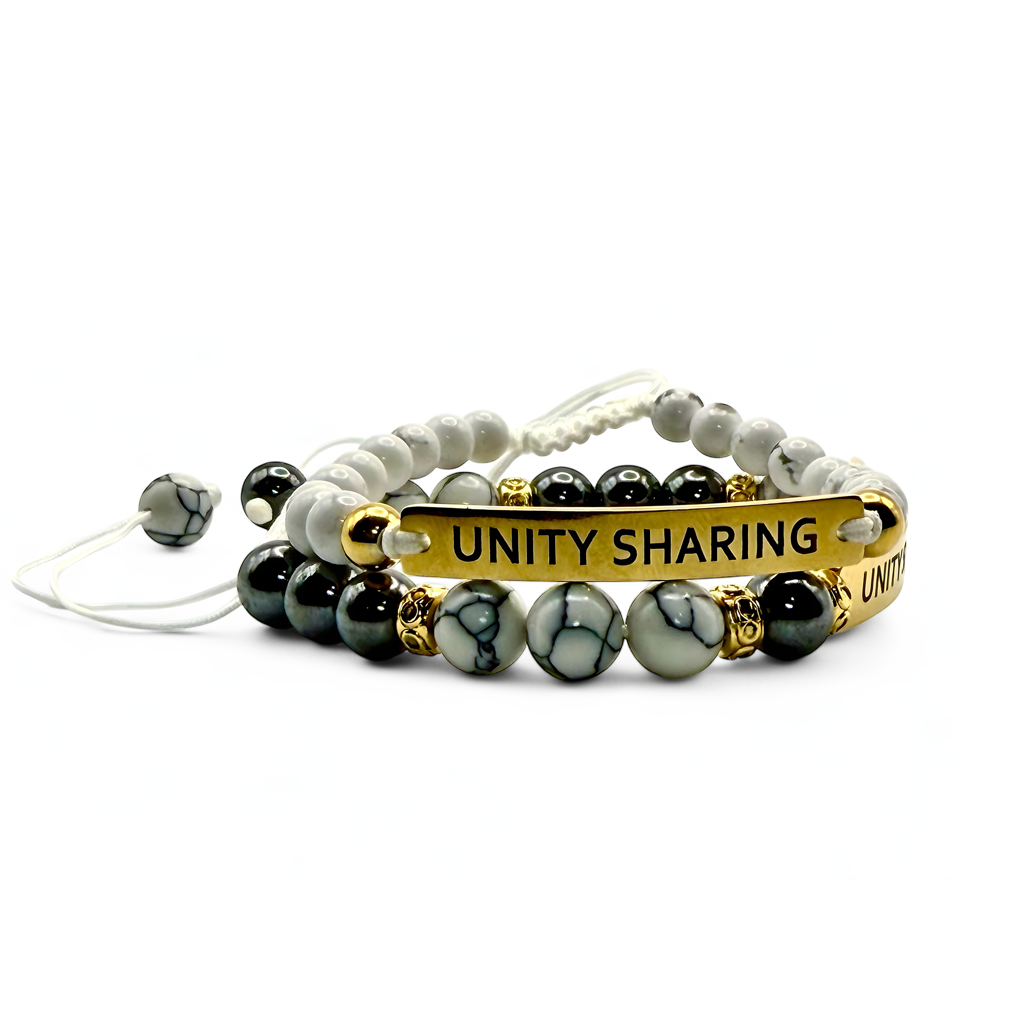 Set of two white beaded bracelets with gold and silver-tone bars engraved “UNITY SHARING” — neutral and stackable bundle.
